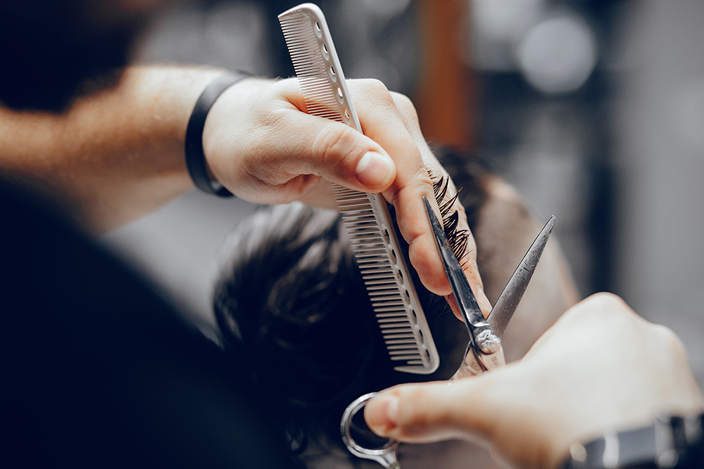 Hairdresser with a client. Man with a beard. Guy in a barbershop