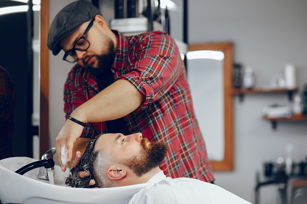 Hairdresser with a client. Man with a beard. Guy in a barbershop